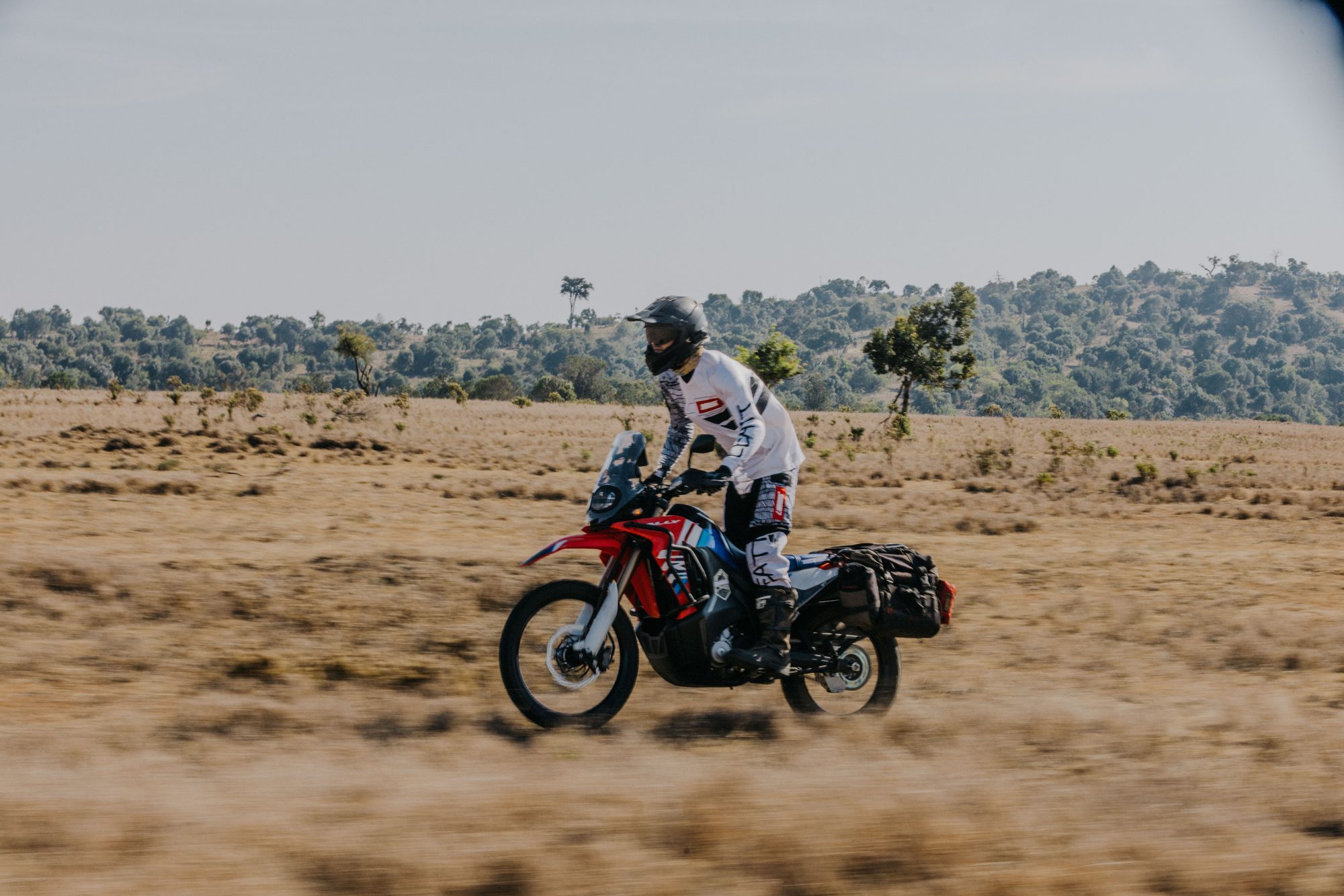 A rider on a loaded Ténéré crossing open grassland