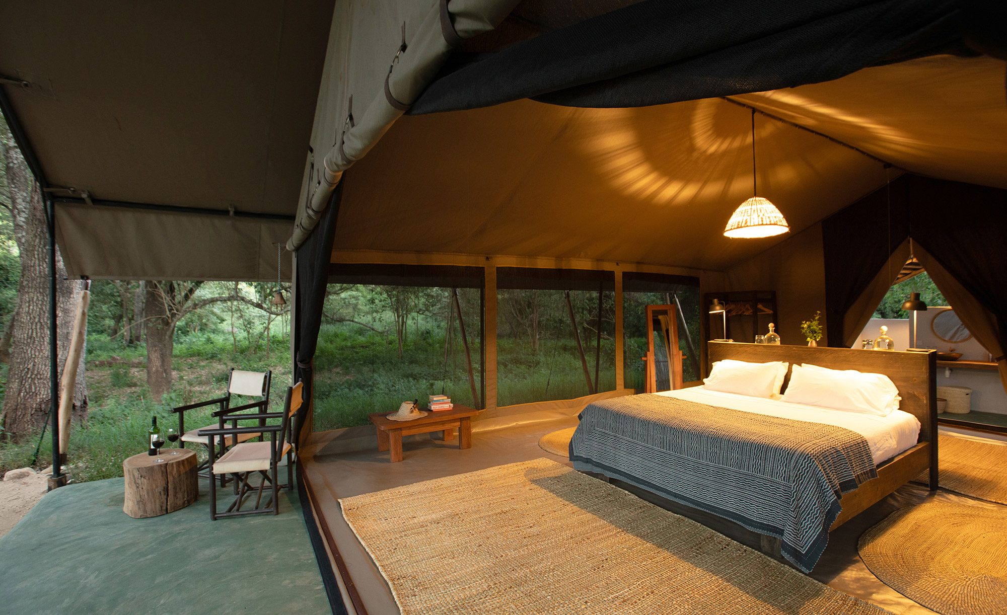 A tented bedroom at Kitich Forest Camp, open to the trees