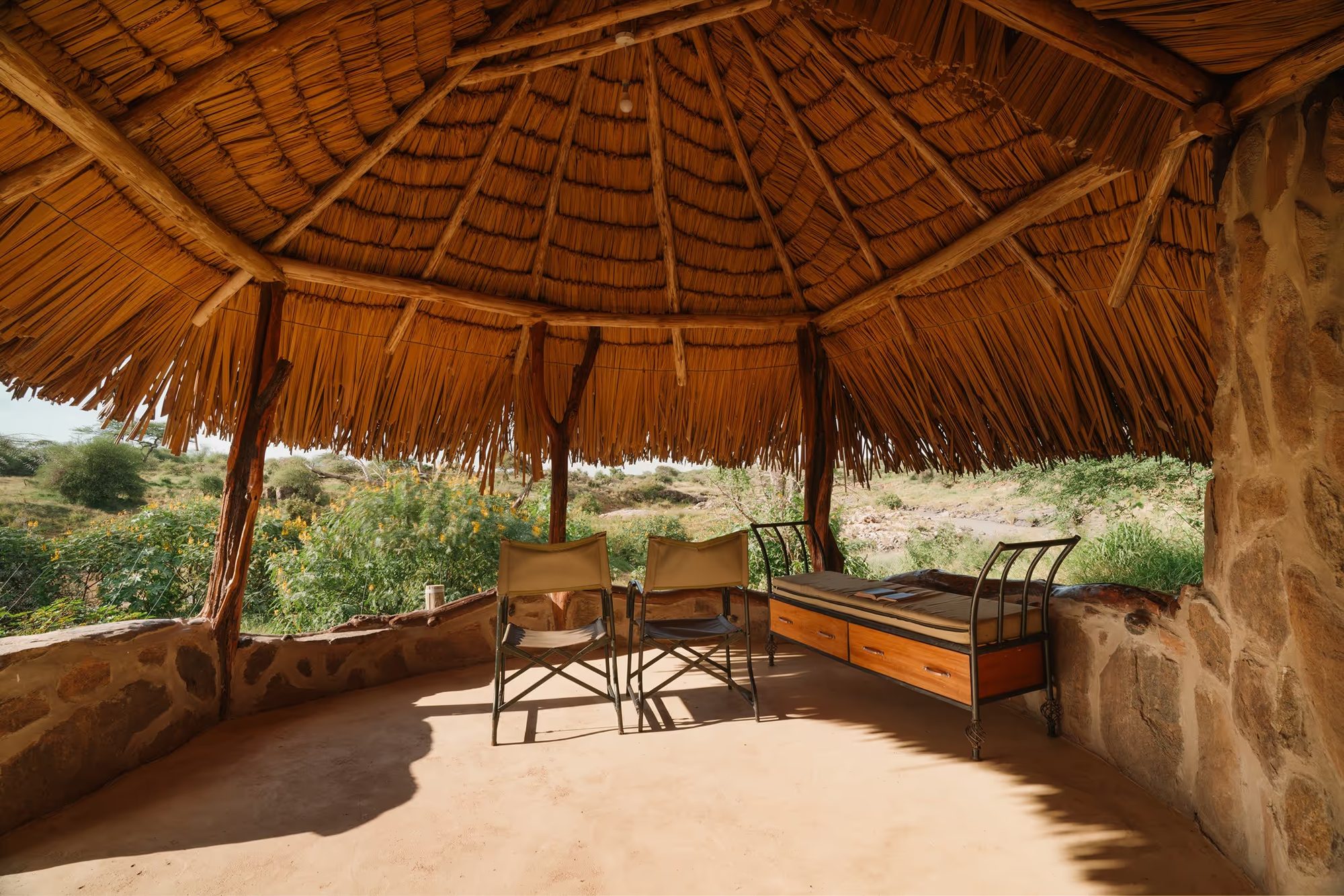 The open-sided lounge of a banda at Ol Gaboli, looking out to the bush